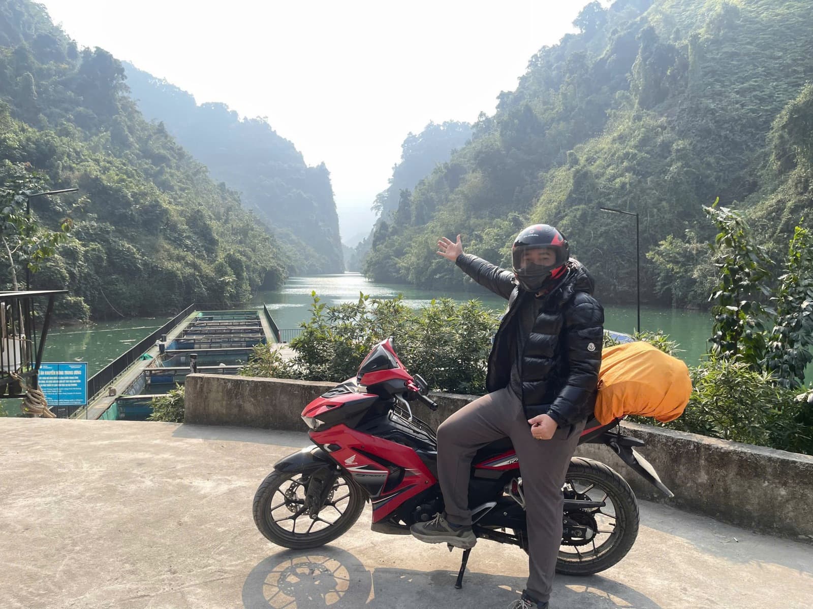 A guest with his rental motorbike beside the river in Ha Giang