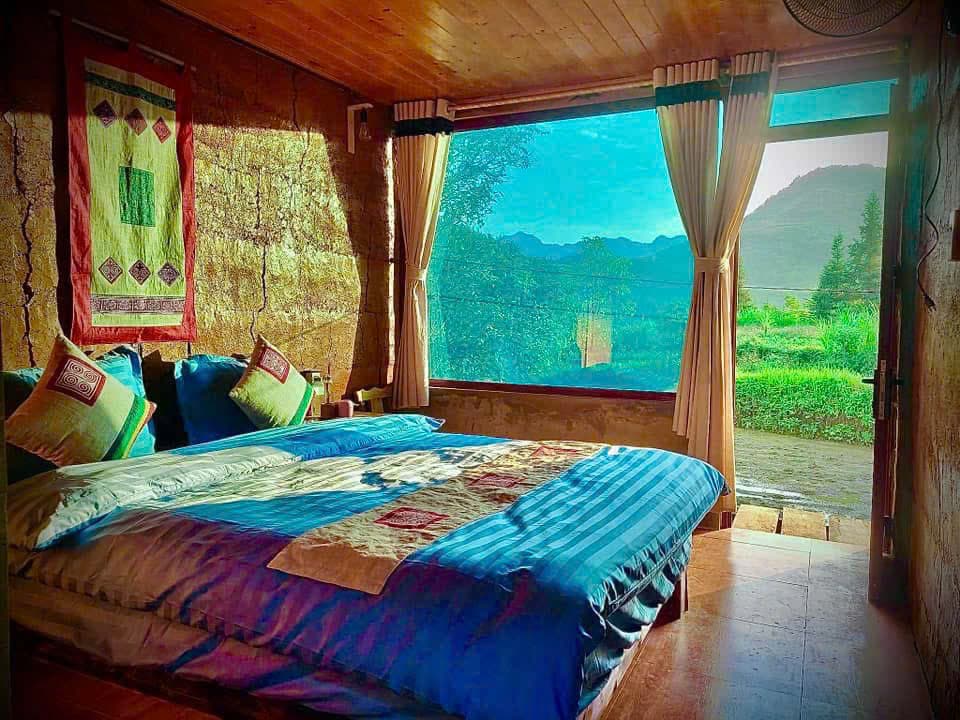 A homestay bedroom with a big window onto the mountains